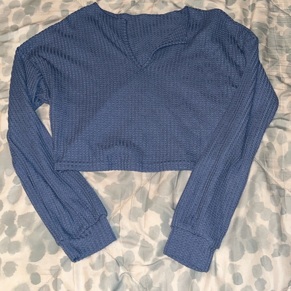 blue cropped shirt. kind of see through. thin material